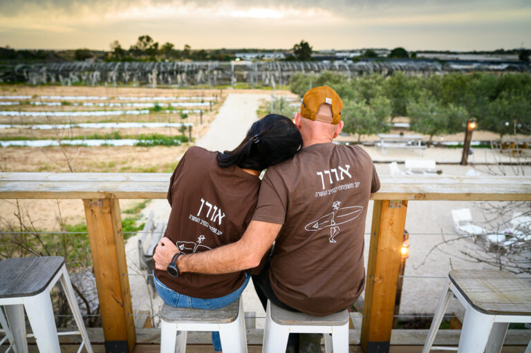 זוג מתחבק על רקע שקיעה